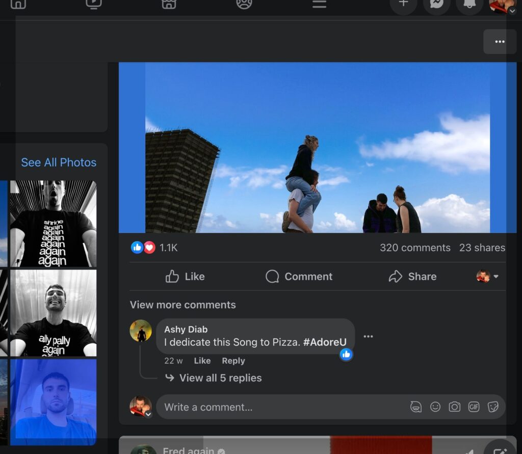A Facebook post by Fred Again featuring an image of a group of people outdoors under a bright blue sky. One person is sitting on another's shoulders, with others nearby. The post has 1.1K reactions, 320 comments, and 23 shares. Below the image, a comment from a user named Ashy Diab humorously states, "I dedicate this Song to Pizza. #AdoreU," with several replies hidden under the "View all 5 replies" option. The interface shows additional photo thumbnails on the left and standard Facebook interaction options like Like, Comment, and Share.