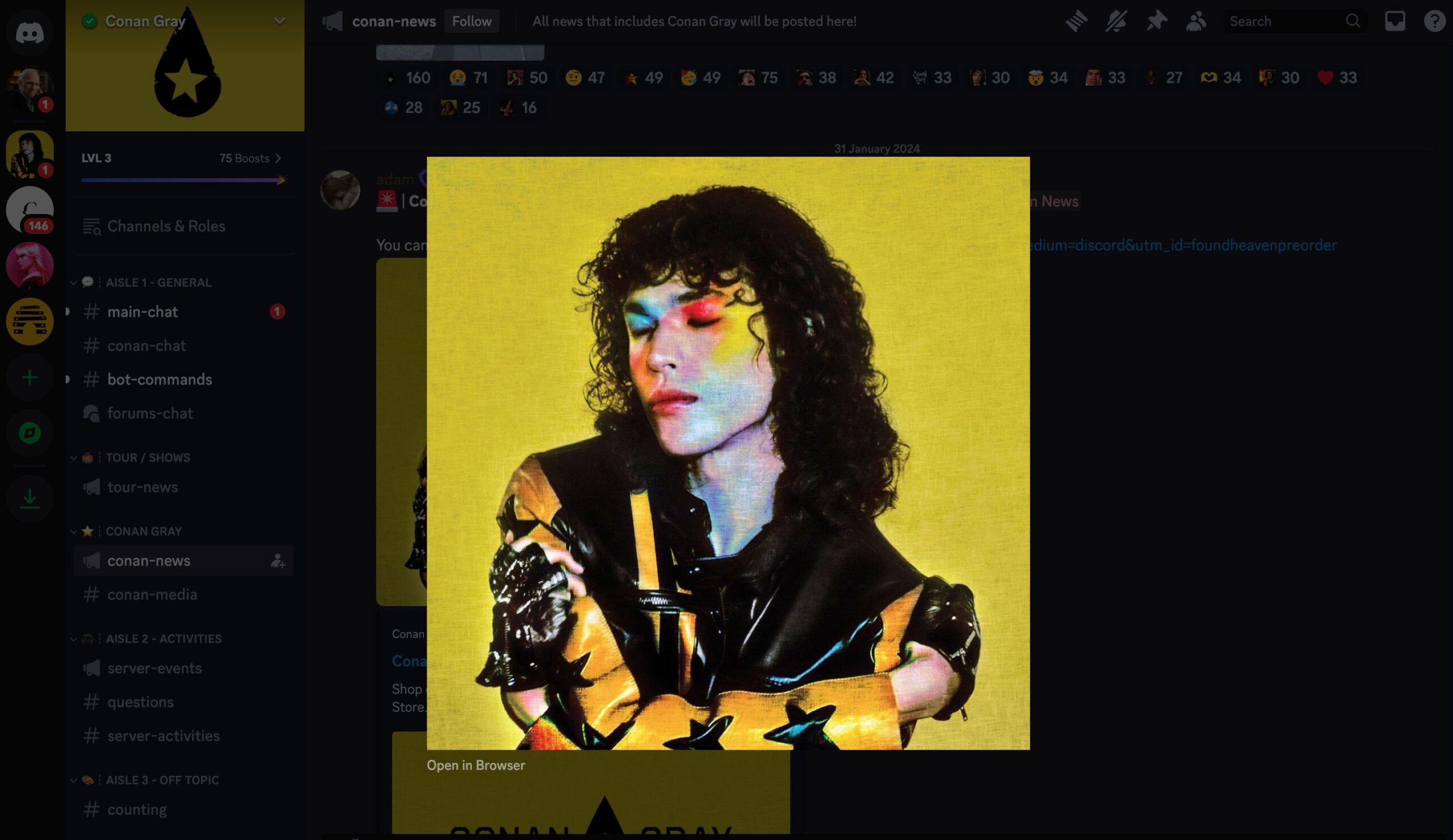A screenshot of a Discord server dedicated to Conan Gray, featuring a prominently displayed image of Conan Gray with a yellow background. He is dressed in a black and yellow outfit with star motifs, his eyes closed and colorful eyeshadow accentuating his features. The server interface shows various channels and notifications on the left, with the "conan-news" channel currently active. The background elements of the Discord interface are dimly lit, allowing the featured image to stand out.